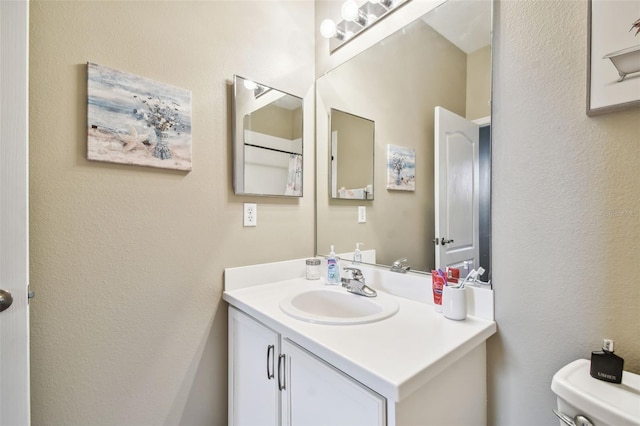 bathroom with toilet and vanity