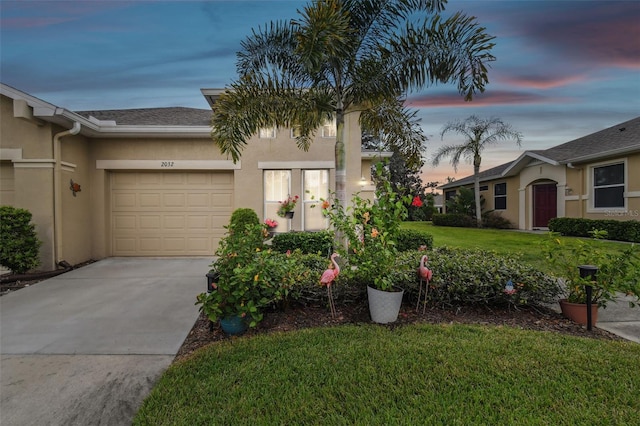 view of front of property with a yard and a garage