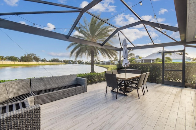 exterior space featuring glass enclosure and a water view