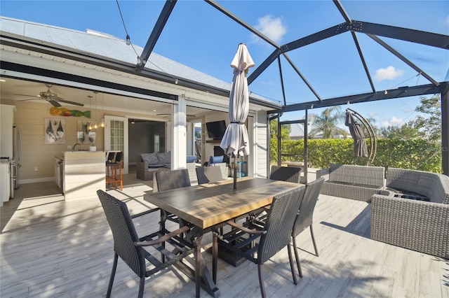 exterior space with ceiling fan, sink, an outdoor living space, and glass enclosure