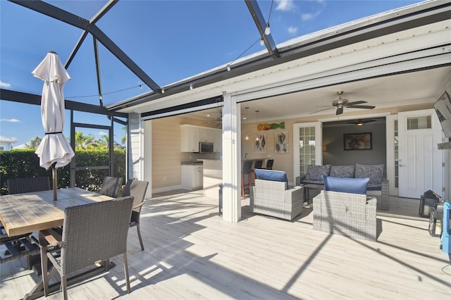 deck with outdoor lounge area, a lanai, and ceiling fan