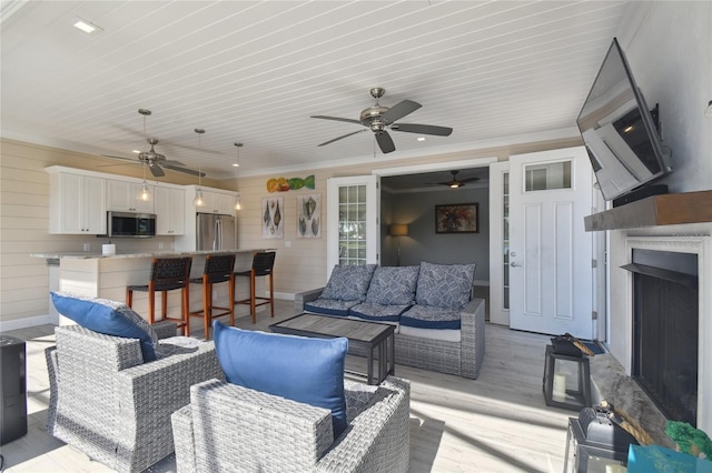 living room featuring ceiling fan and light wood-type flooring