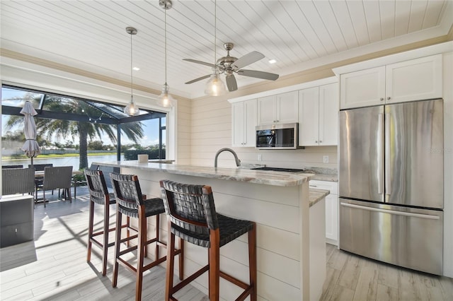 kitchen featuring light stone countertops, white cabinetry, ceiling fan, and appliances with stainless steel finishes