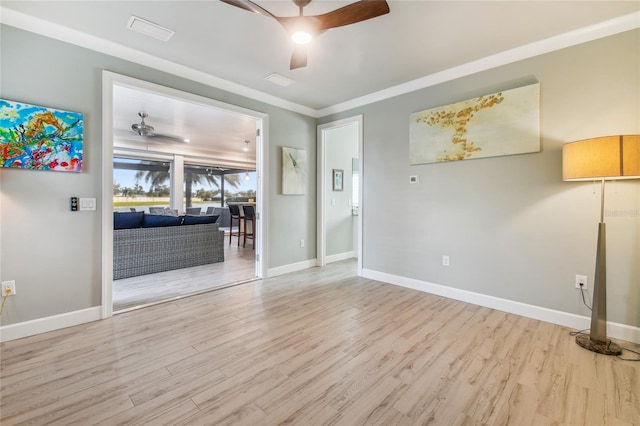 empty room with ornamental molding, light hardwood / wood-style floors, and ceiling fan