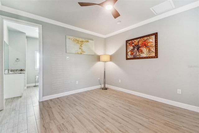 spare room featuring ceiling fan and light hardwood / wood-style flooring