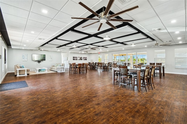 dining area with ceiling fan and dark hardwood / wood-style floors