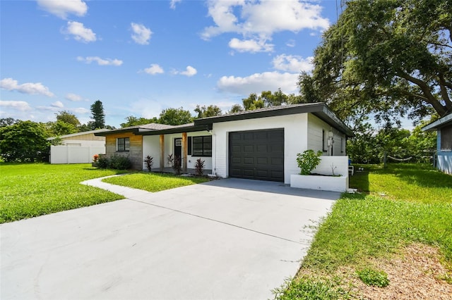 ranch-style house with a garage and a front lawn