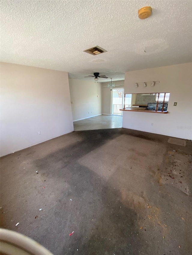 unfurnished living room featuring a textured ceiling and ceiling fan