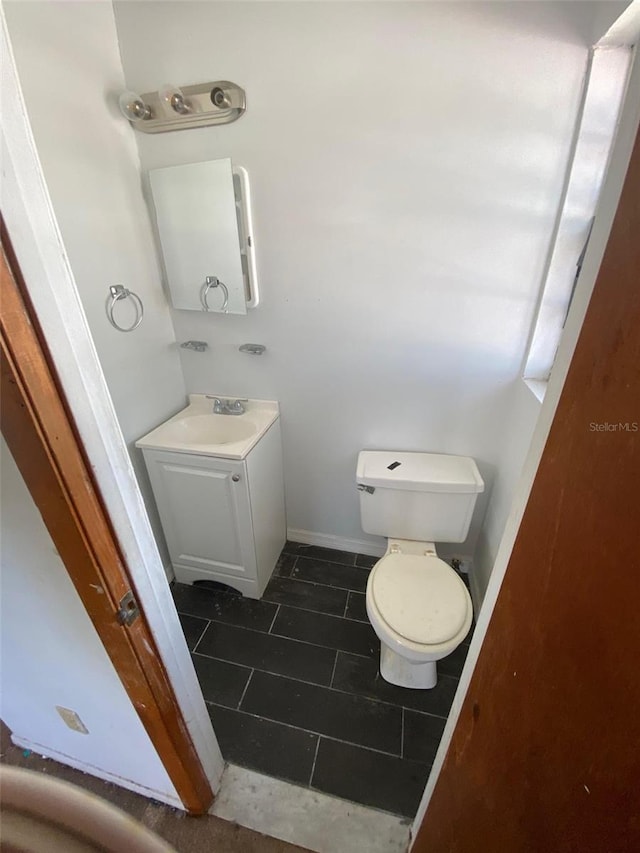 bathroom featuring vanity, toilet, and tile patterned floors