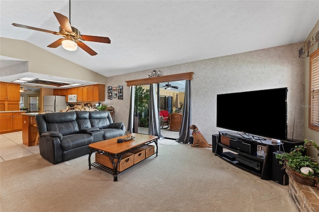 carpeted living room with a textured ceiling, ceiling fan, and vaulted ceiling