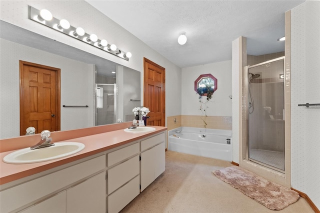 bathroom with vanity, a textured ceiling, and independent shower and bath