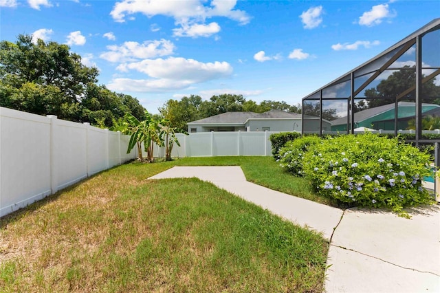 view of yard featuring a lanai and a patio area