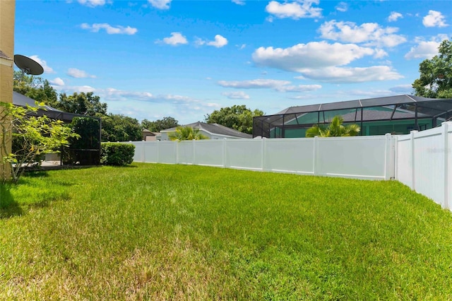 view of yard with glass enclosure