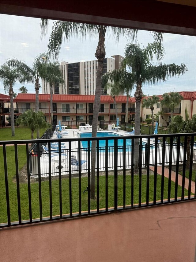 view of pool featuring a lawn