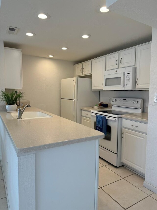 kitchen featuring kitchen peninsula, sink, light tile patterned floors, white appliances, and white cabinets