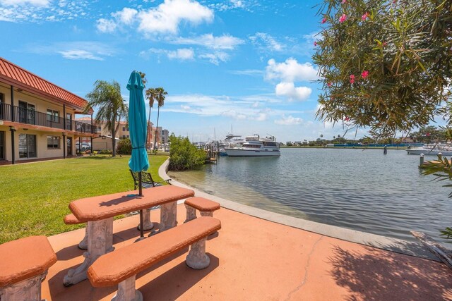 view of property's community with a yard and a water view