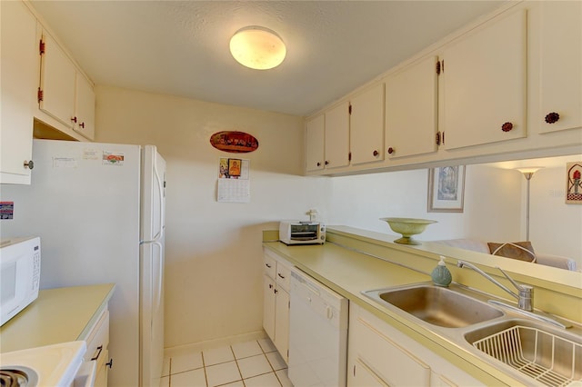 kitchen with sink, light tile patterned floors, white cabinetry, a textured ceiling, and white appliances