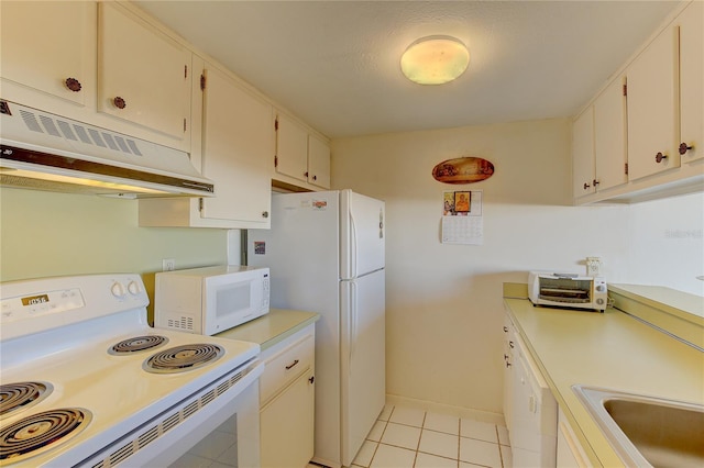 kitchen with white appliances, sink, white cabinets, light tile patterned floors, and exhaust hood