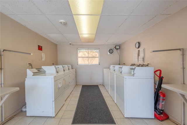 laundry room featuring light tile patterned flooring and washing machine and dryer