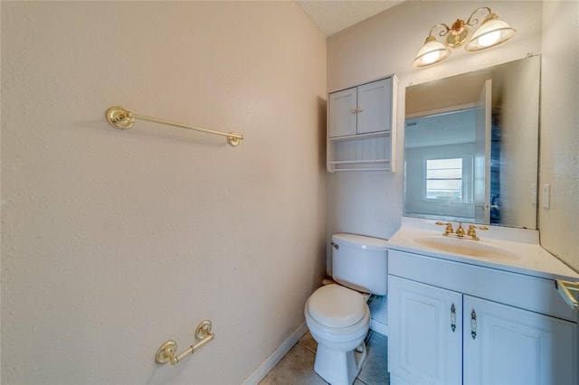 bathroom with vanity, toilet, and tile patterned floors