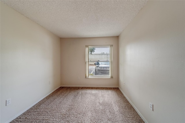 spare room featuring a textured ceiling and carpet flooring