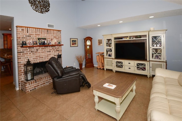 7519 Harbor View Way, Seminole, FL 33776 - living area with tile patterned floors, visible vents, recessed lighting, a high ceiling, and a brick fireplace