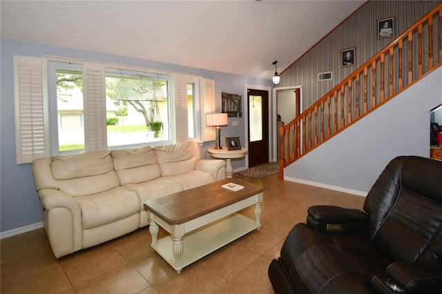 7519 Harbor View Way, Seminole, FL 33776 - living room featuring baseboards, tile patterned flooring, wallpapered walls, lofted ceiling, and stairs
