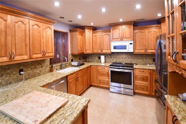 7519 Harbor View Way, Seminole, FL 33776 - kitchen with a sink, stainless steel appliances, light stone countertops, and recessed lighting