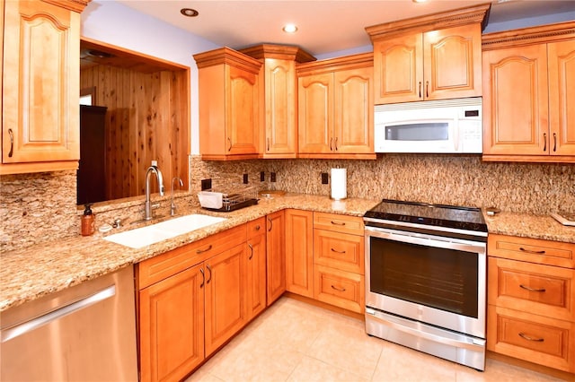 7519 Harbor View Way, Seminole, FL 33776 - kitchen with a sink, backsplash, appliances with stainless steel finishes, light tile patterned floors, and light stone countertops