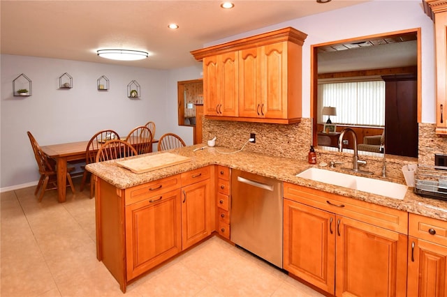 7519 Harbor View Way, Seminole, FL 33776 - kitchen featuring a sink, light stone countertops, stainless steel dishwasher, and a peninsula
