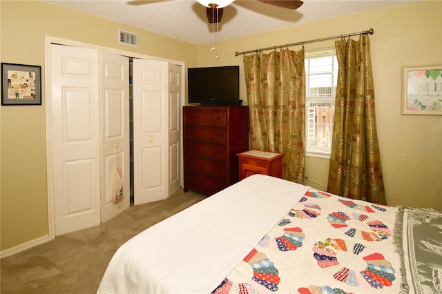 7519 Harbor View Way, Seminole, FL 33776 - bedroom featuring visible vents, a textured ceiling, a closet, carpet flooring, and ceiling fan