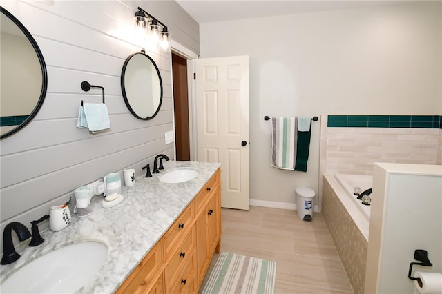 7519 Harbor View Way, Seminole, FL 33776 - bathroom with tiled bath, tile patterned floors, double vanity, and a sink