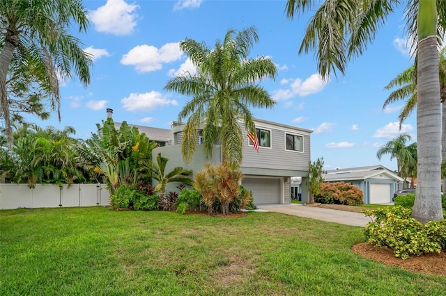 view of front of property with a garage and a front lawn