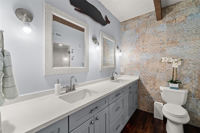 bathroom featuring hardwood / wood-style flooring, vanity, toilet, and beamed ceiling