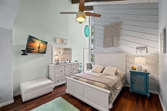 bedroom with dark hardwood / wood-style floors, high vaulted ceiling, ceiling fan, and wood walls