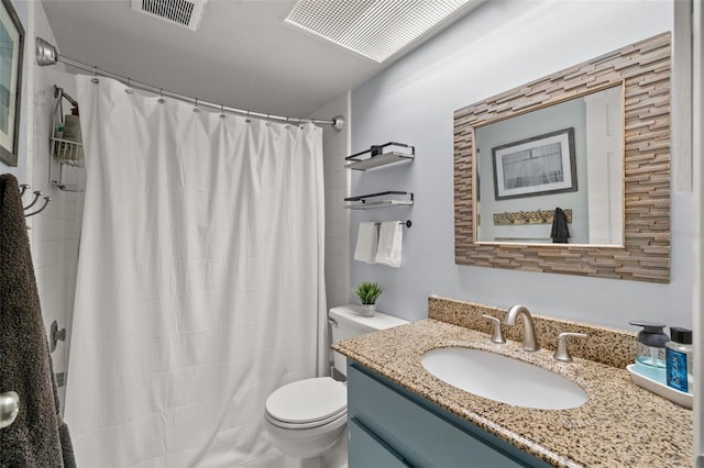 bathroom featuring curtained shower, vanity, and toilet