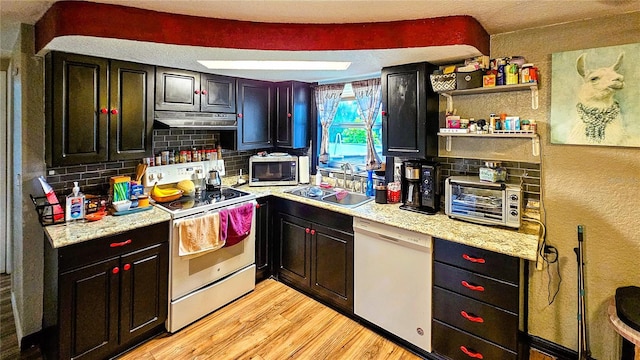 kitchen with light hardwood / wood-style flooring, range hood, sink, white appliances, and tasteful backsplash