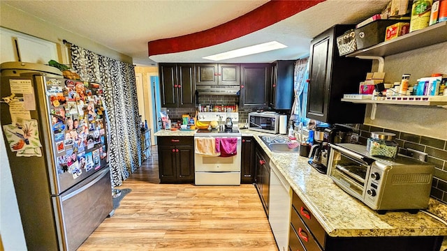 kitchen featuring dark brown cabinets, appliances with stainless steel finishes, light hardwood / wood-style flooring, and decorative backsplash