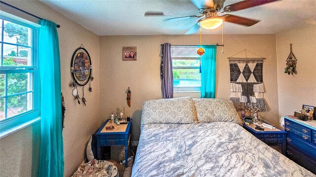 bedroom with multiple windows and ceiling fan