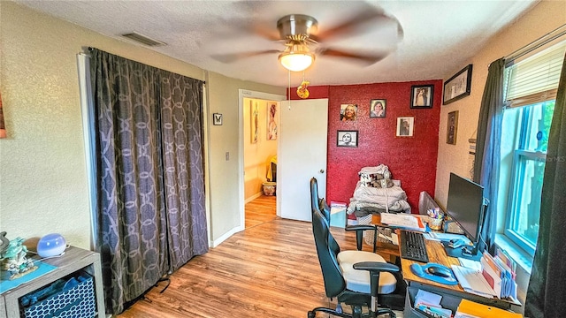 office space with ceiling fan and light wood-type flooring