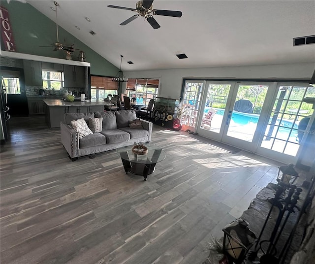 living room with high vaulted ceiling, hardwood / wood-style floors, and ceiling fan