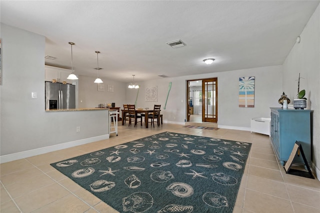 interior space featuring light tile patterned floors and a notable chandelier