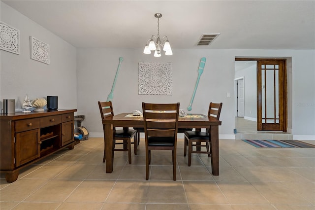 dining area featuring light tile patterned floors and a notable chandelier