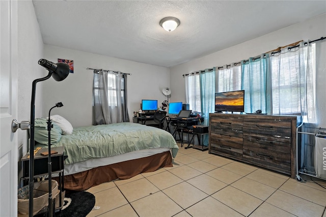 tiled bedroom with a textured ceiling