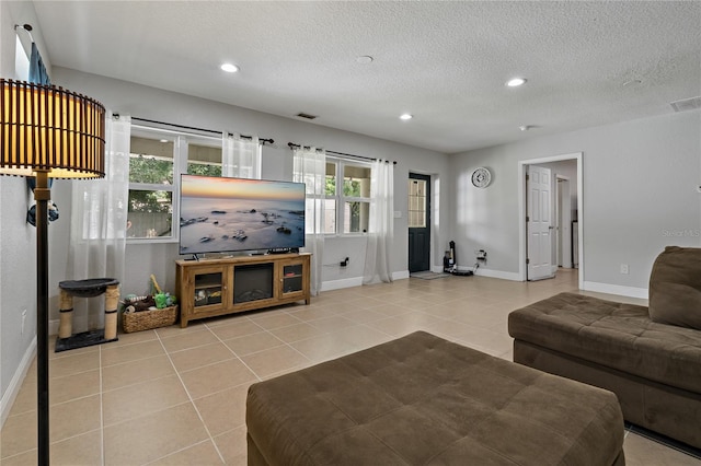 tiled living room with a textured ceiling