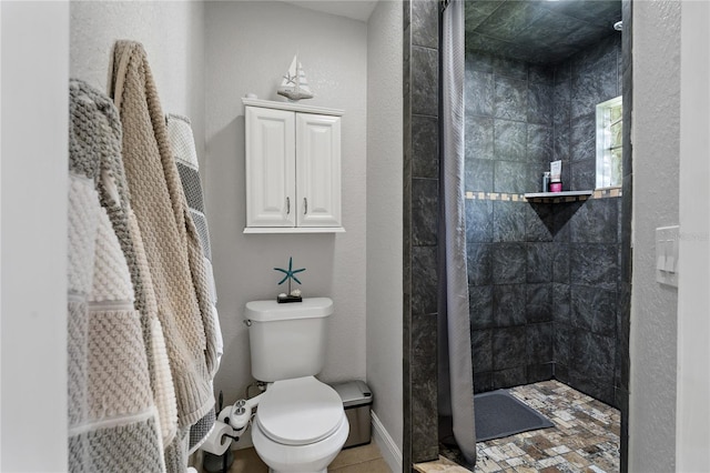 bathroom with tiled shower and toilet