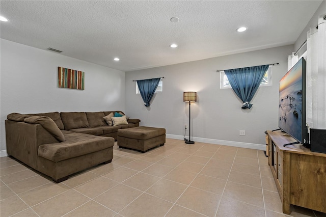 tiled living room featuring a textured ceiling