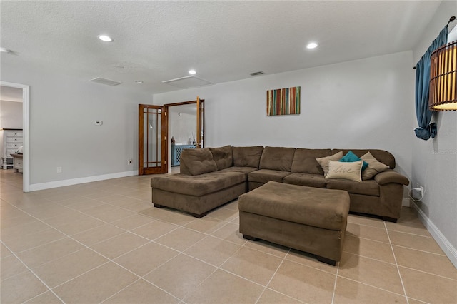 tiled living room with a textured ceiling