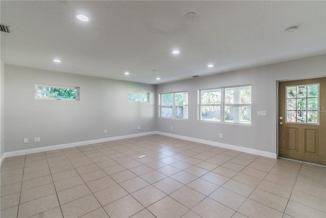 unfurnished room featuring light tile patterned floors