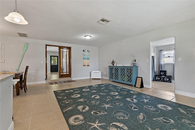 unfurnished room featuring french doors and light tile patterned floors